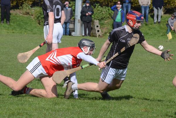 George Feeney of St Francis College Rochestown manages to handpass the sliothar despite being brought to the ground by Eoghan Fraser of Midleton CBS during the Cork Post Primary U16 A Hurling final which was played in Cobh. Picture: Howard Crowdy